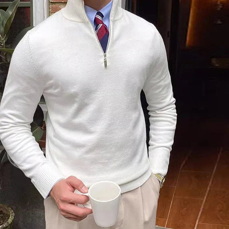 Men’s half zip pullover sweater styled with beige trousers for a smart casual look.