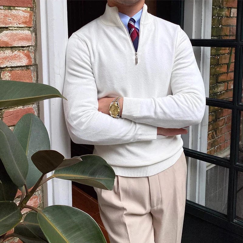 Men’s half zip pullover sweater styled with beige trousers for a smart casual look.